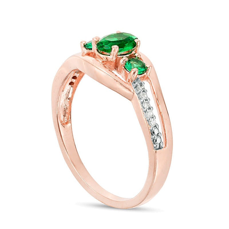 Oval Lab-Created Emerald and 0.05 CT. TW Diamond Three Stone Bypass Engagement Ring in 10K Rose Gold