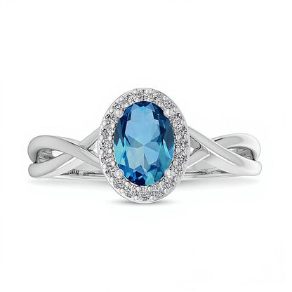 Oval Swiss Blue Topaz and 0.07 CT. TW Diamond Frame Crossover Shank Ring in 10K White Gold