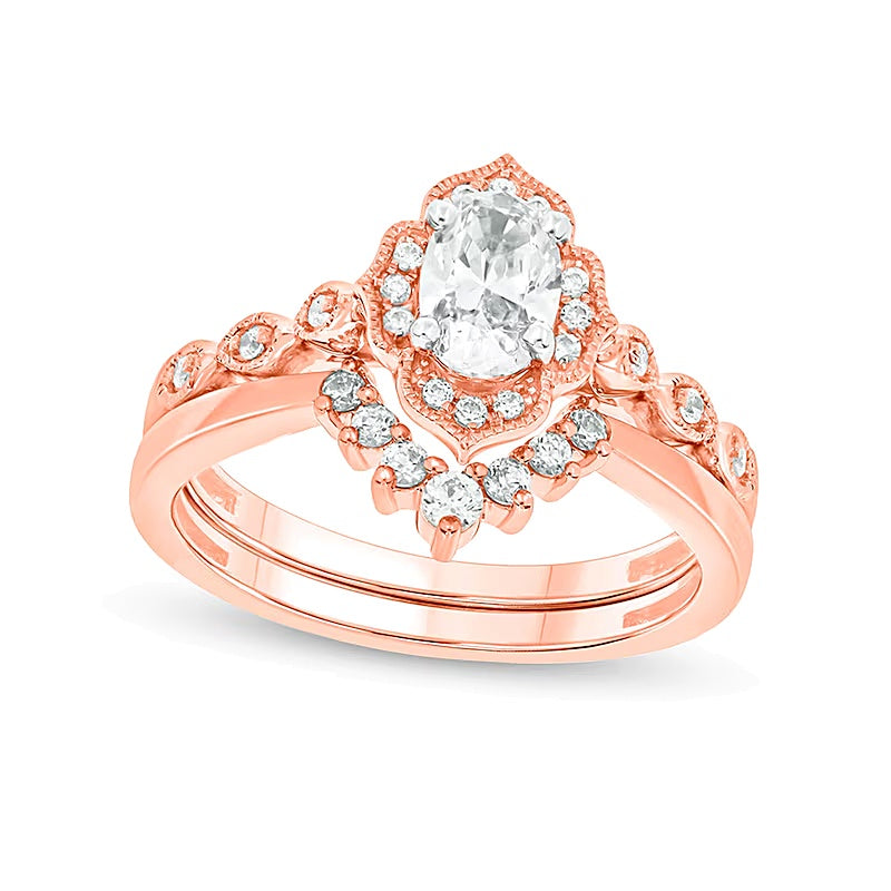 0.75 CT. TW Oval Diamond Frame Vintage-Style Bridal Set in 14K Rose Gold (I/I2)