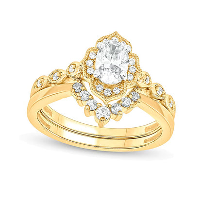 0.75 CT. TW Oval Diamond Frame Vintage-Style Bridal Set in 14K Gold (I/I2)