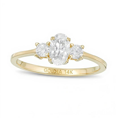 0.63 CT. TW Oval and Round Diamond Three Stone Engagement Ring in 14K Gold