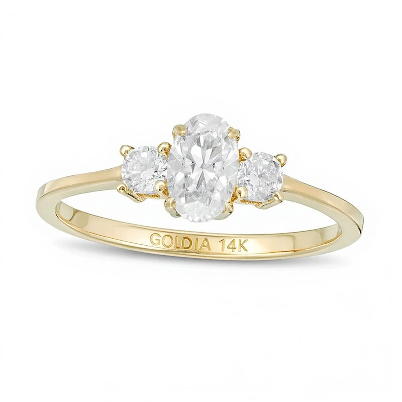 0.63 CT. TW Oval and Round Diamond Three Stone Engagement Ring in 14K Gold