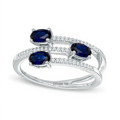 Oval Blue Sapphire and 0.1 CT. TW Diamond Three Stone Wrap Ring in 10K White Gold