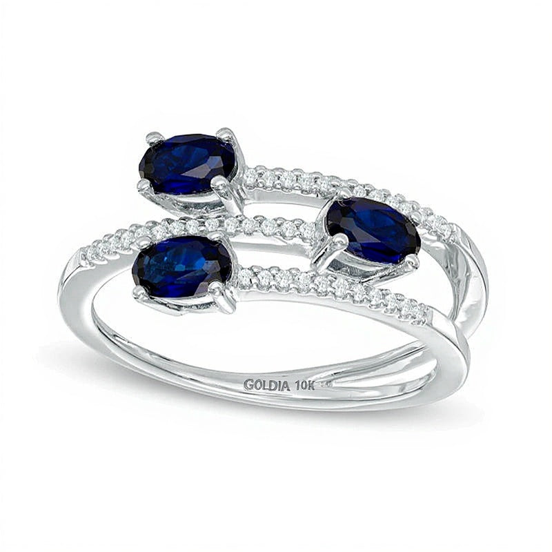 Oval Blue Sapphire and 0.1 CT. TW Diamond Three Stone Wrap Ring in 10K White Gold