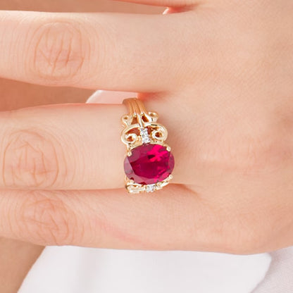 Oval Lab-Created Ruby and 0.05 CT. TW Diamond Vintage-Style Scroll Ring in 10K Gold