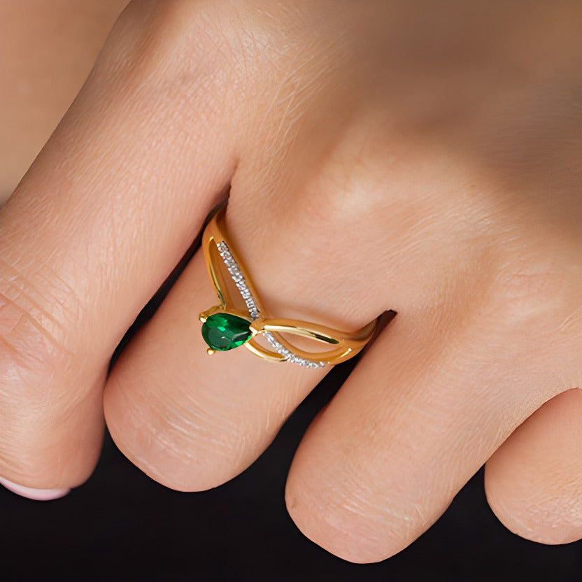 Pear-Shaped Lab-Created Emerald and 0.05 CT. TW Diamond Wave Ribbon Split Shank Promise Ring in 10K Gold
