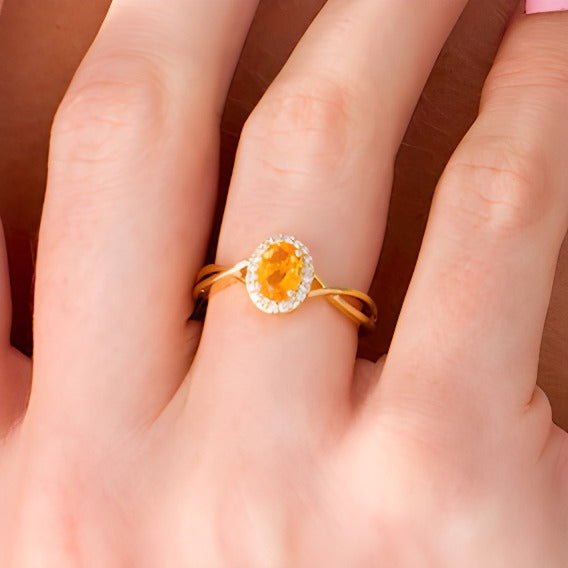Oval Citrine and 0.07 CT. TW Diamond Frame Twist Shank Ring in 10K Gold