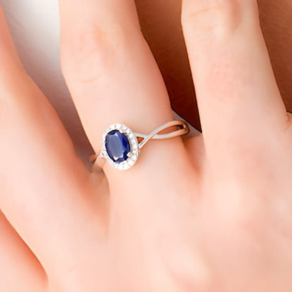 Oval Blue Sapphire and 0.07 CT. TW Diamond Frame Twist Shank Ring in 10K White Gold