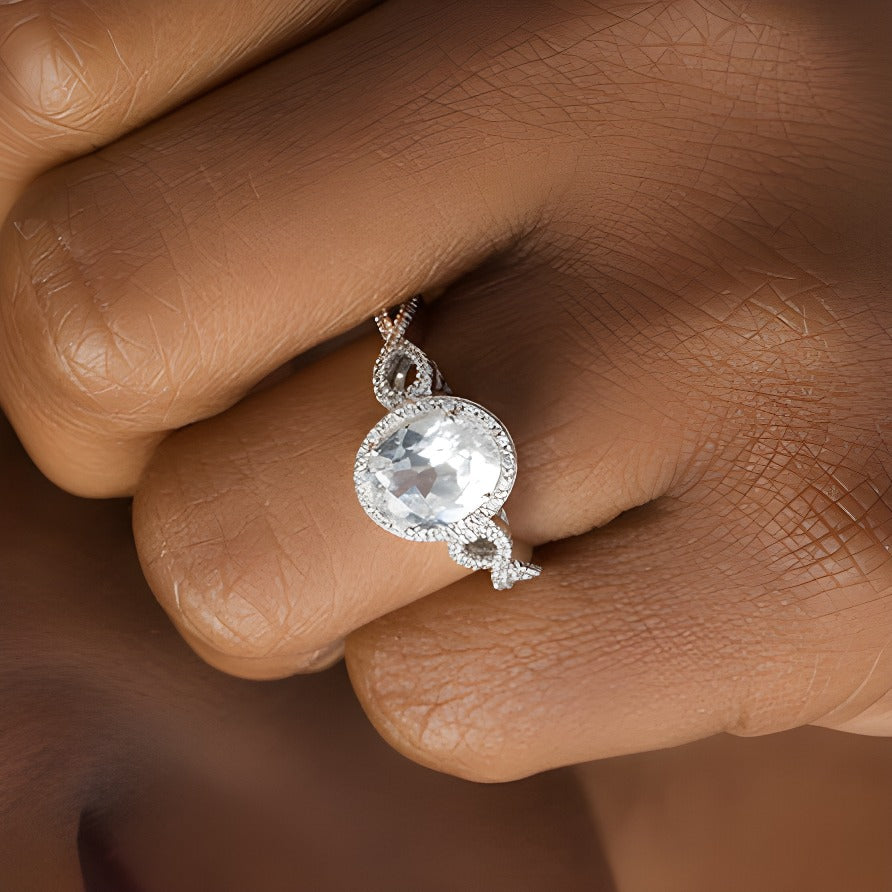 Oval Lab-Created White Sapphire and 0.17 CT. TW Diamond Frame Infinity Shank Engagement Ring in Sterling Silver