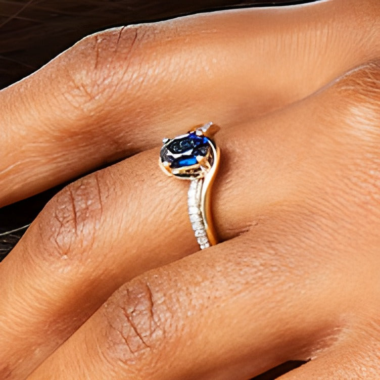 Oval Blue Lab-Created Sapphire and 0.1 CT. TW Diamond Bypass Ring in 10K Gold