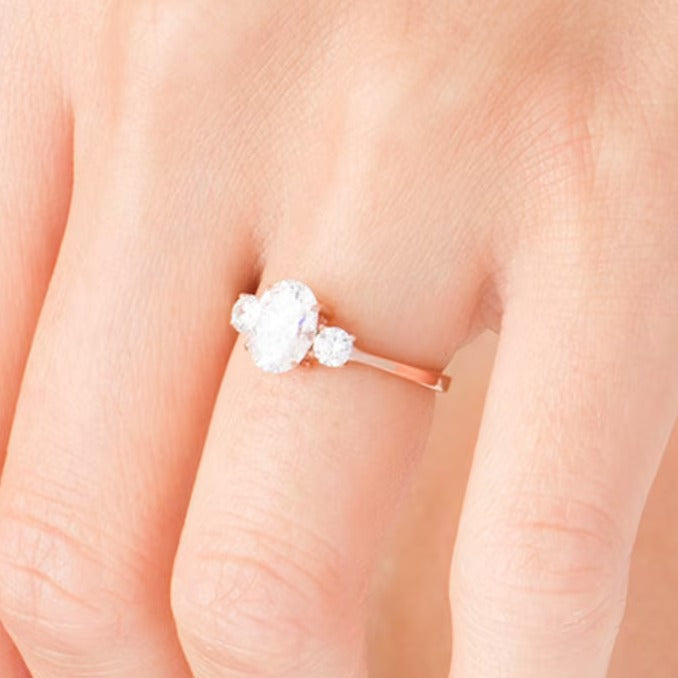 1.25 CT. TW Oval and Round Diamond Three Stone Engagement Ring in 14K Rose Gold