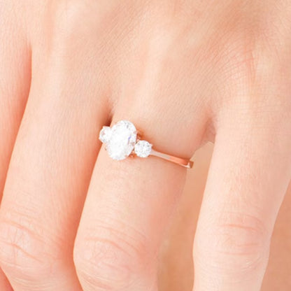 1.25 CT. TW Oval and Round Diamond Three Stone Engagement Ring in 14K Rose Gold