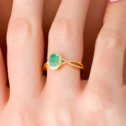 Oval Emerald and 0.07 CT. TW Diamond Frame Twist Shank Ring in 10K Gold