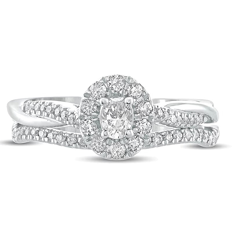 0.5 CT. TW Oval Diamond Frame Twist Shank Bridal Set in 10K White Gold