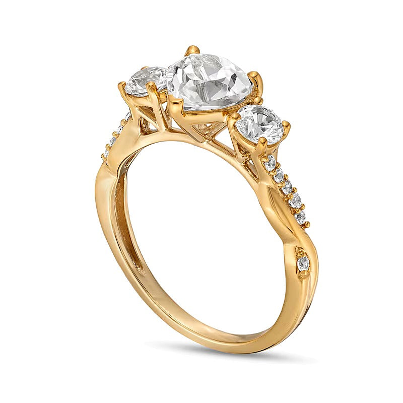 Heart-Shaped White Lab-Created Sapphire and 0.1 CT. TW Diamond Three Stone Twist Shank Engagement Ring in 10K Gold