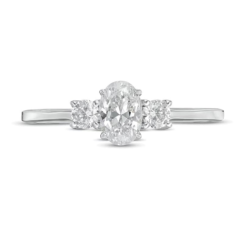 0.63 CT. TW Oval and Round Diamond Three Stone Engagement Ring in 14K White Gold