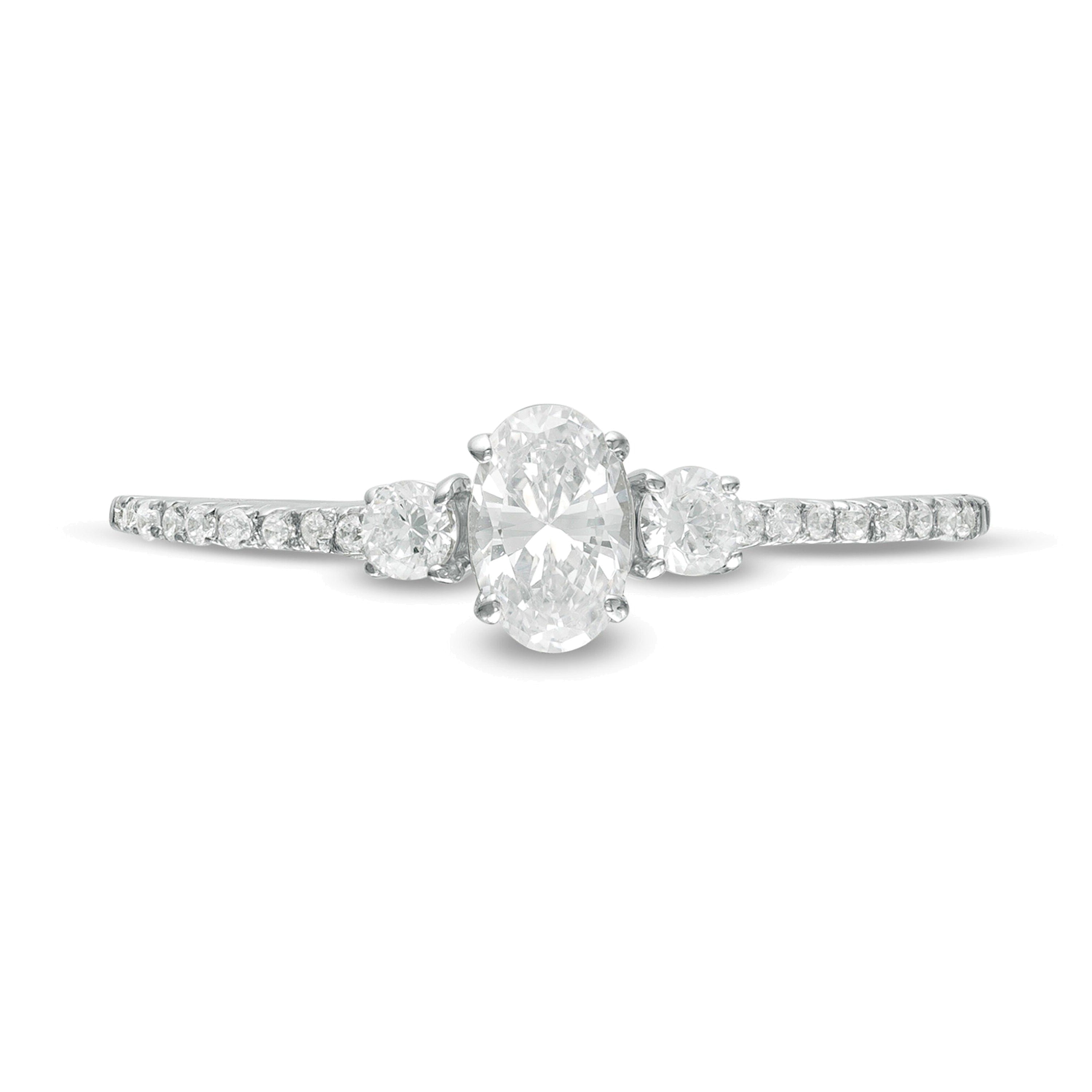 0.63 CT. TW Oval and Round Diamond Three Stone Engagement Ring in 14K White Gold