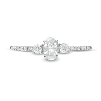 0.63 CT. TW Oval and Round Diamond Three Stone Engagement Ring in 14K White Gold
