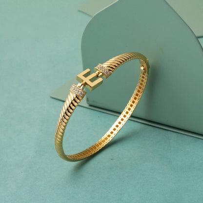 14K Yellow Gold E Initial Twisted Cubic Zirconia Hinged Cuff Bangle