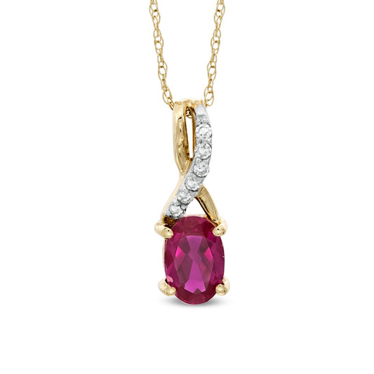 Oval Lab-Created Ruby and Diamond Accent Twist Pendant in 10K Yellow Gold