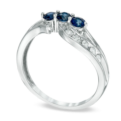 Blue Sapphire and 0.20 CT. T.W. Natural Diamond Three Stone Bypass Ring in Solid 10K White Gold