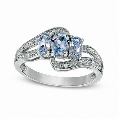 Oval Simulated Aquamarine and Lab-Created White Sapphire Three Stone Bypass Ring in Sterling Silver