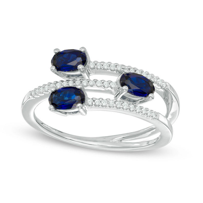 Oval Blue Sapphire and 0.10 CT. T.W. Natural Diamond Three Stone Wrap Ring in Solid 10K White Gold