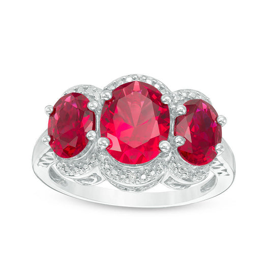 Oval Lab-Created Ruby and Diamond Accent Three Stone Frame Ring in Sterling Silver