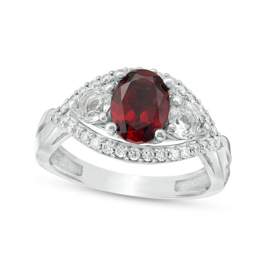 Oval Garnet, White Topaz and 0.25 CT. T.W. Natural Diamond Three Stone Frame Crossover Shank Ring in Solid 10K White Gold