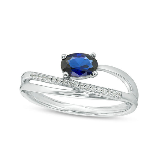 Sideways Oval Lab-Created Blue Sapphire and 0.05 CT. T.W. Diamond Crossover Ribbon Promise Ring in Sterling Silver