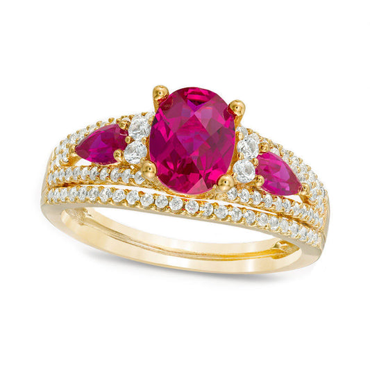 Oval Lab-Created Ruby and 0.50 CT. T.W. Diamond Three Stone Ring in Solid 10K Yellow Gold
