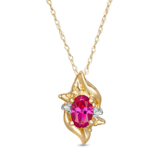 Oval Lab-Created Ruby and Diamond Accent Flame Burst Pendant in 10K Yellow Gold