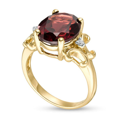 Oval Garnet and 0.05 CT. T.W. Natural Diamond Scroll Frame Ring in Solid 10K Yellow Gold