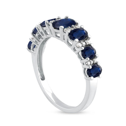 Oval Blue Sapphire and 0.17 CT. T.W. Natural Diamond Graduated Seven Stone Alternating Trios Ring in Solid 10K White Gold