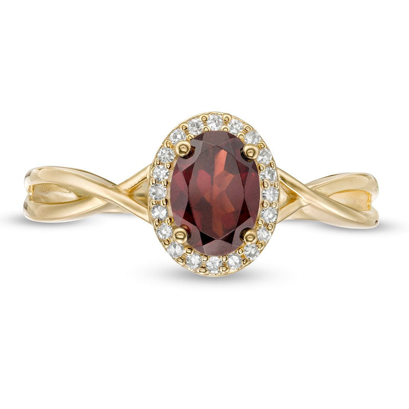 Oval Garnet and 0.07 CT. T.W. Natural Diamond Frame Twist Shank Ring in Solid 10K Yellow Gold