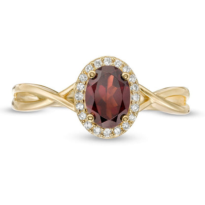 Oval Garnet and 0.07 CT. T.W. Natural Diamond Frame Twist Shank Ring in Solid 10K Yellow Gold