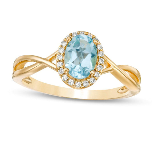 Oval Swiss Blue Topaz and 0.07 CT. T.W. Natural Diamond Frame Twist Shank Ring in Solid 10K Yellow Gold