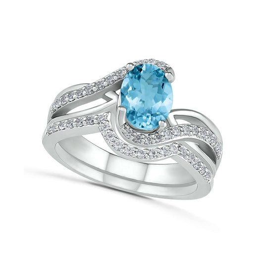Oval Aquamarine and 0.10 CT. T.W. Natural Diamond Bypass Split Shank Bridal Engagement Ring Set in Sterling Silver