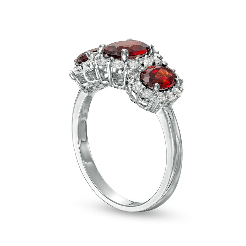 Oval Garnet and White Lab-Created Sapphire Frame Three Stone Ring in Sterling Silver