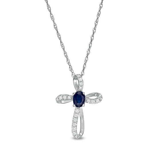 Oval Blue Sapphire and 0.1 CT. T.W. Natural Diamond Pinwheel Cross Pendant in 10K White Gold