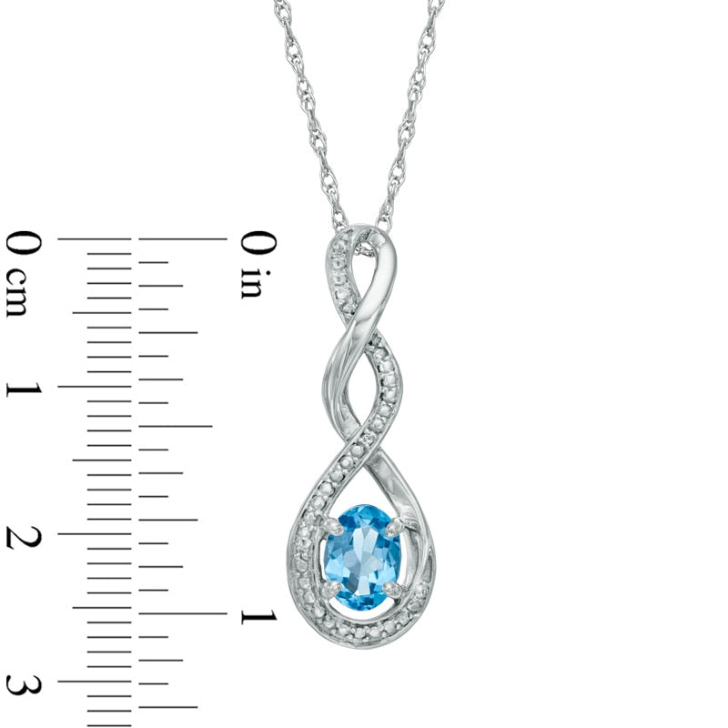 Oval Blue Topaz and Natural Diamond Accent Infinity Twist Pendant in Sterling Silver