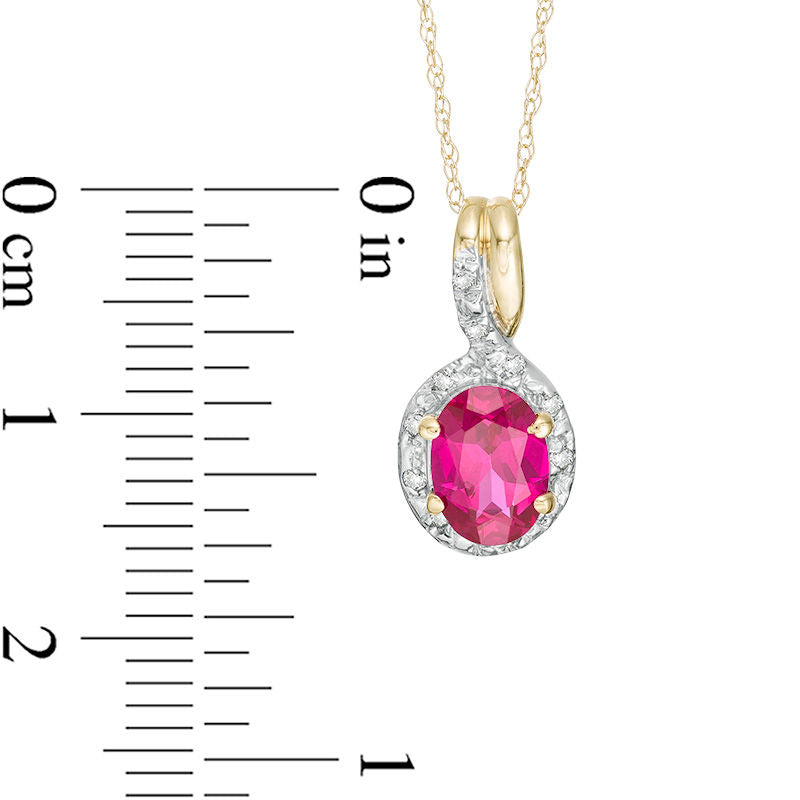 Oval Lab-Created Ruby and 0.05 CT. T.W. Diamond Frame Bypass Pendant in 10K Yellow Gold