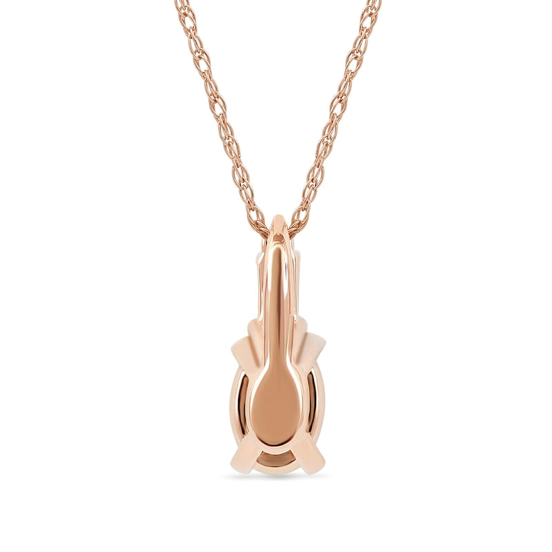 Oval Ruby and 0.05 CT. T.W. Baguette and Round Natural Diamond Stacked Top Accent Pendant in 10K Rose Gold