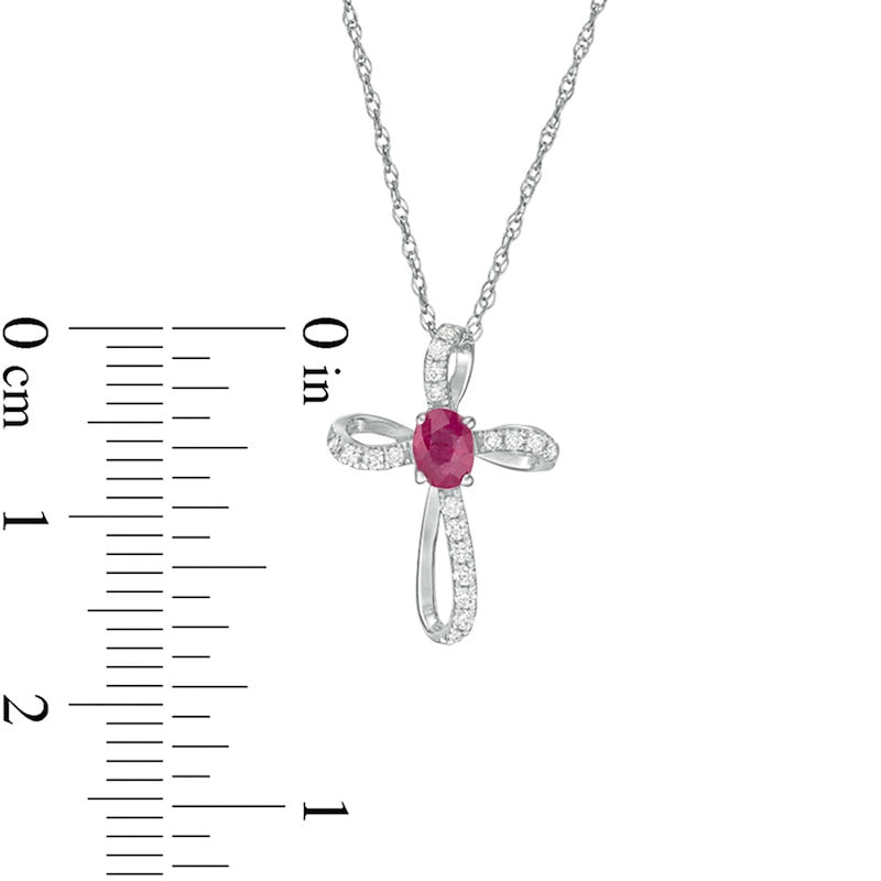 Oval Ruby and 0.1 CT. T.W. Natural Diamond Pinwheel Cross Pendant in 10K White Gold