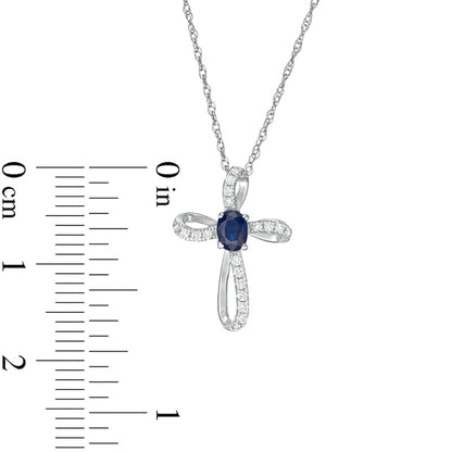 Oval Blue Sapphire and 0.1 CT. T.W. Natural Diamond Pinwheel Cross Pendant in 10K White Gold